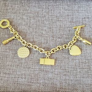 Estee Lauder Gold Tone Charm Toggle Bracelet 8" Length Heart Lipstick Perfume